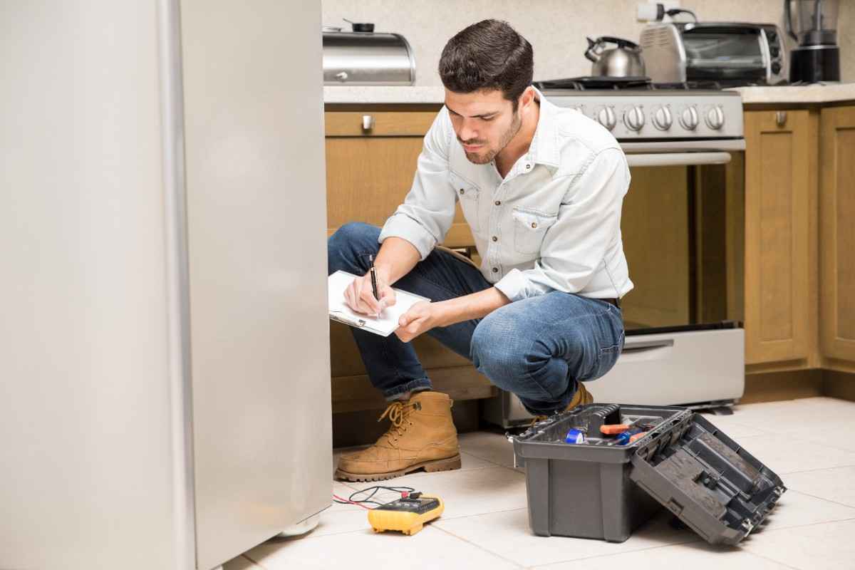 technician-doing-work-report-broken-fridge-home-kitchen Areas We Service Around Albion Park